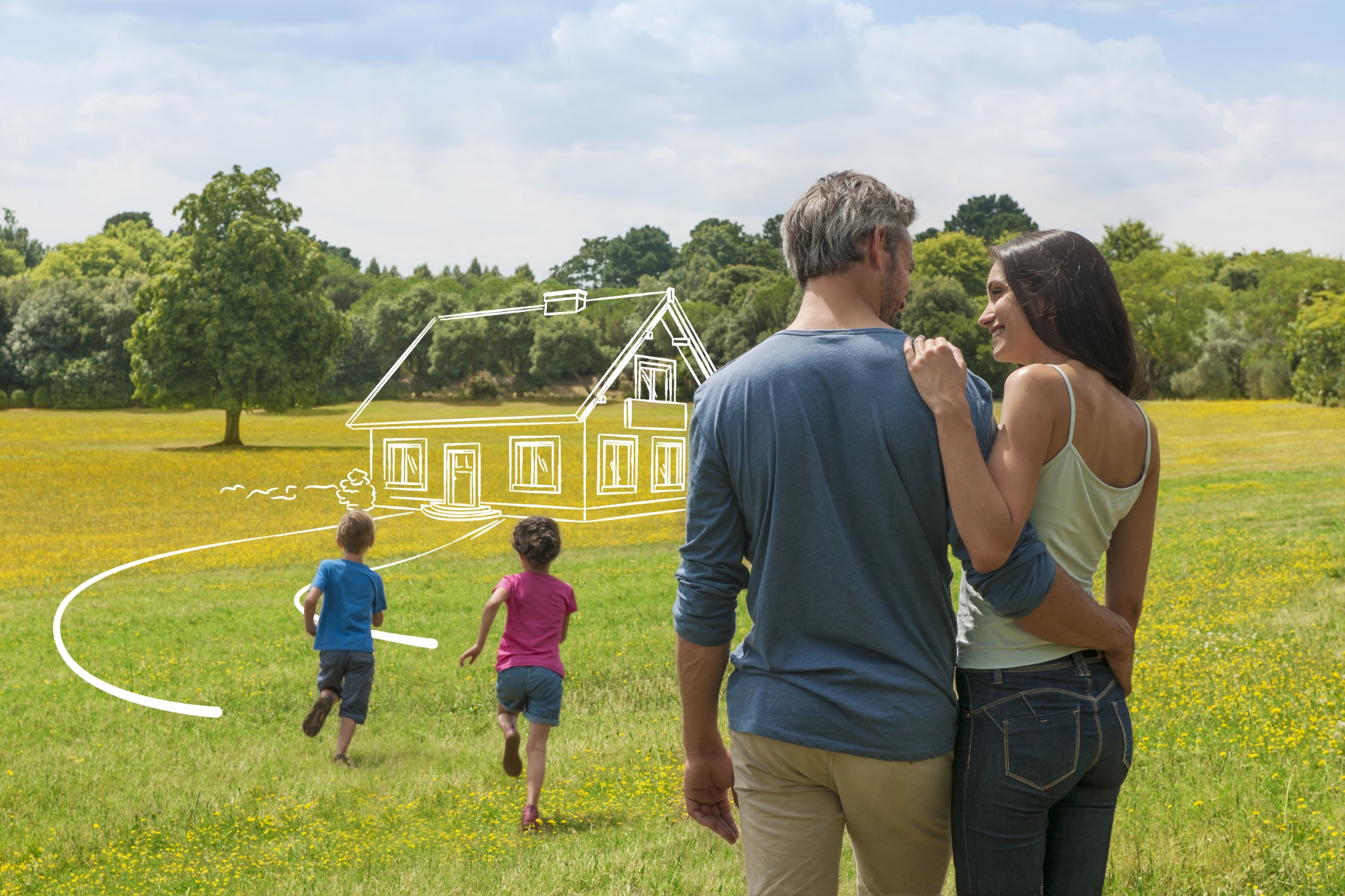 Familie auf einer Wiese – die Vorstellung vom eigenen Baugrundstück